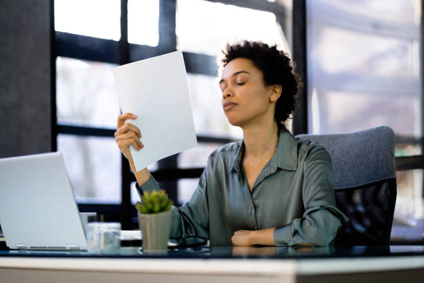 Hot Office Weather. Woman Sweating At Work solar control window film