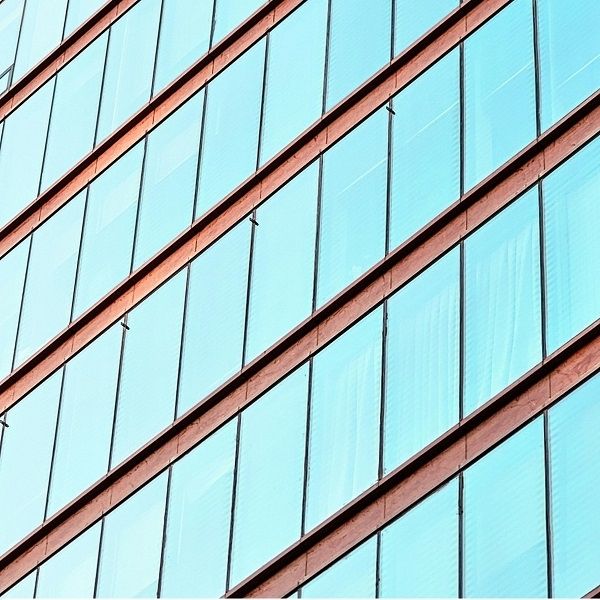 Office building with reflective films that reduce heat coming though windows.