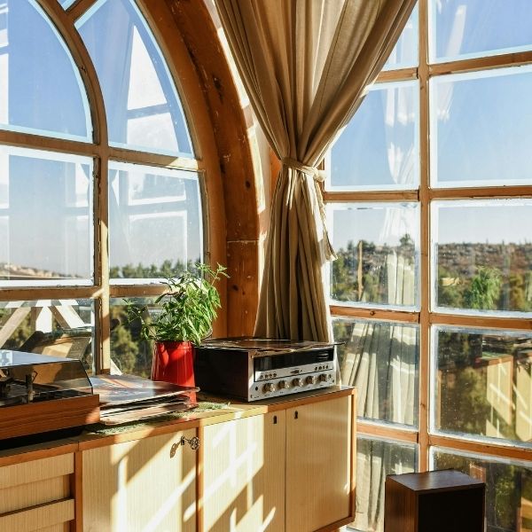 Sun rays on wooden floor, furniture, and appliances.