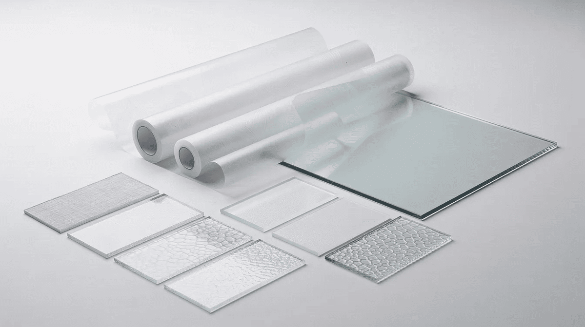 Frosted glass film options Frosted glass window films and textured samples alongside a plain pane of glass